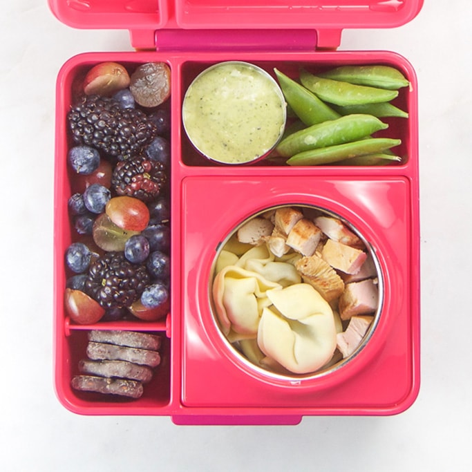 Pink school lunch box filled with healthy and colorful school lunch ideas for kids.