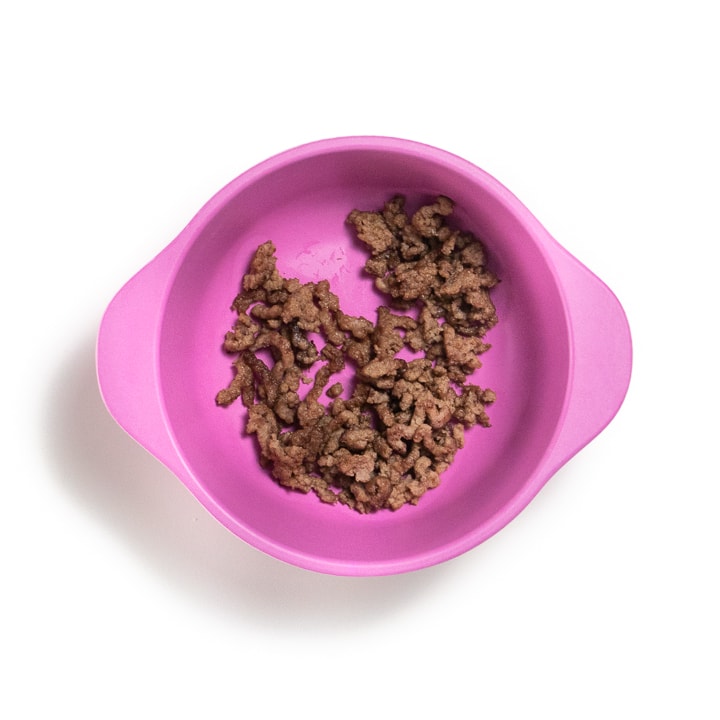 Pink bowl with ground beef.