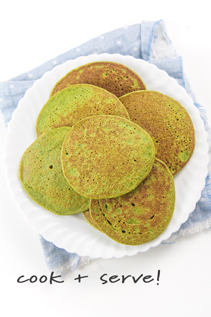 spinach pancakes piled on a plate.