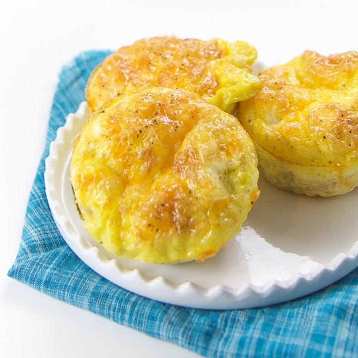 Small white plate with three quinoa and cheese egg muffins.