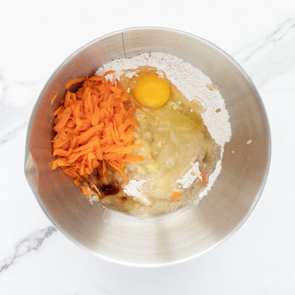 Silver mixing bowl with ingredients for ABC muffins.