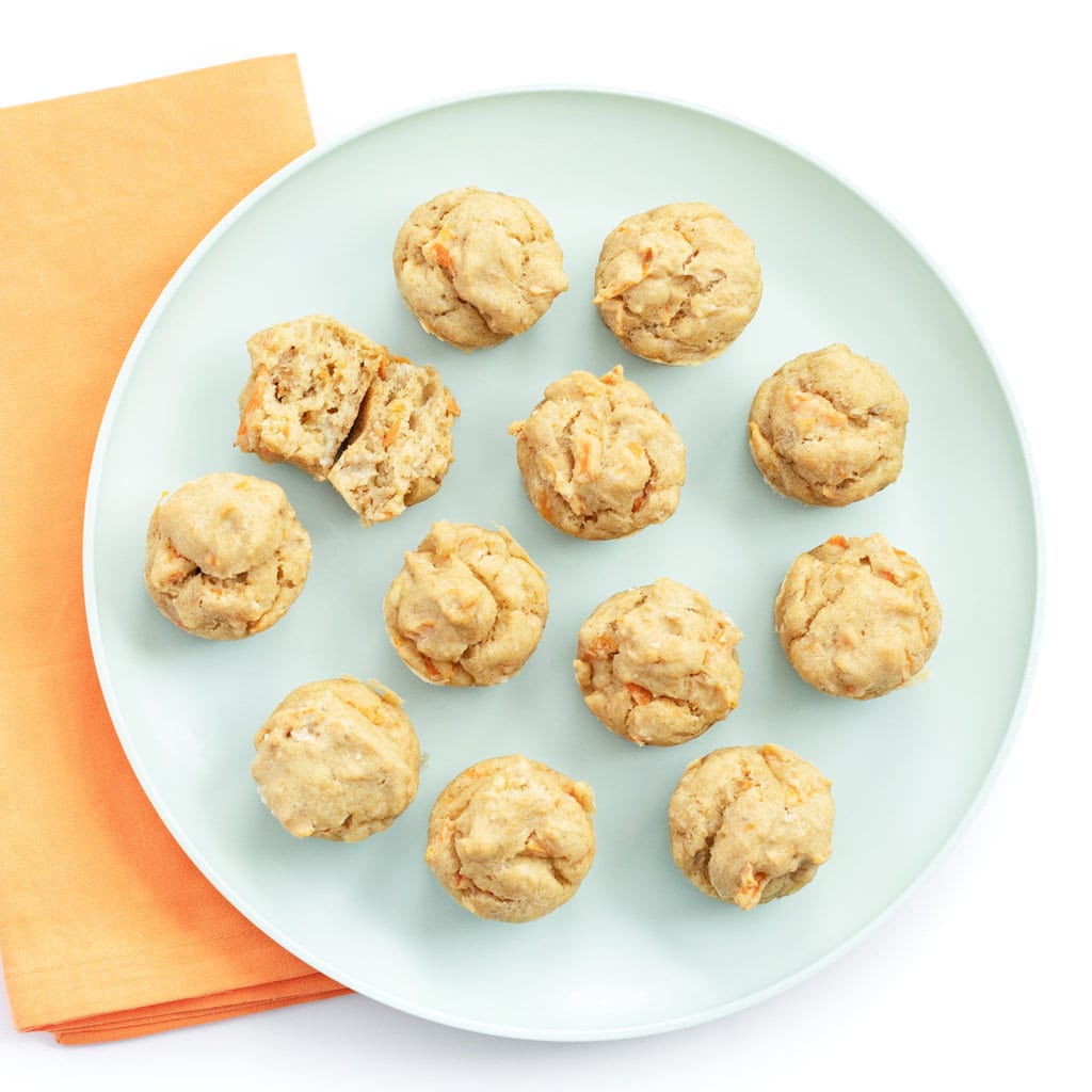 A teal plate with ABC muffins on top against a white background and an orange napkin.