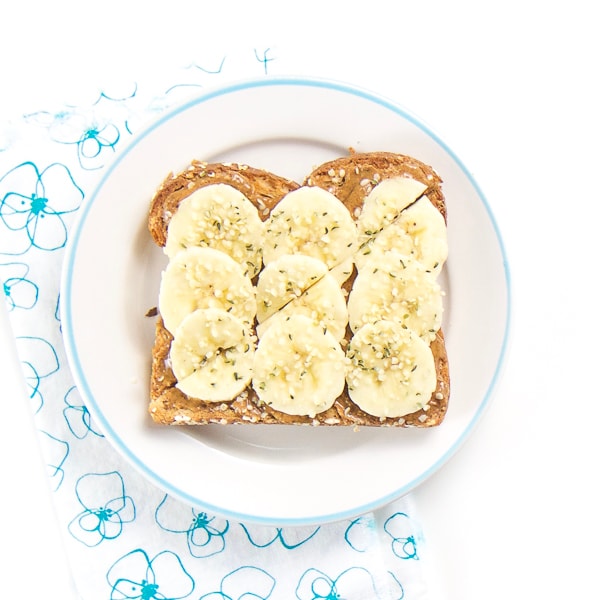 almond toast with bananas and hemp sprinkles for baby and toddler. 