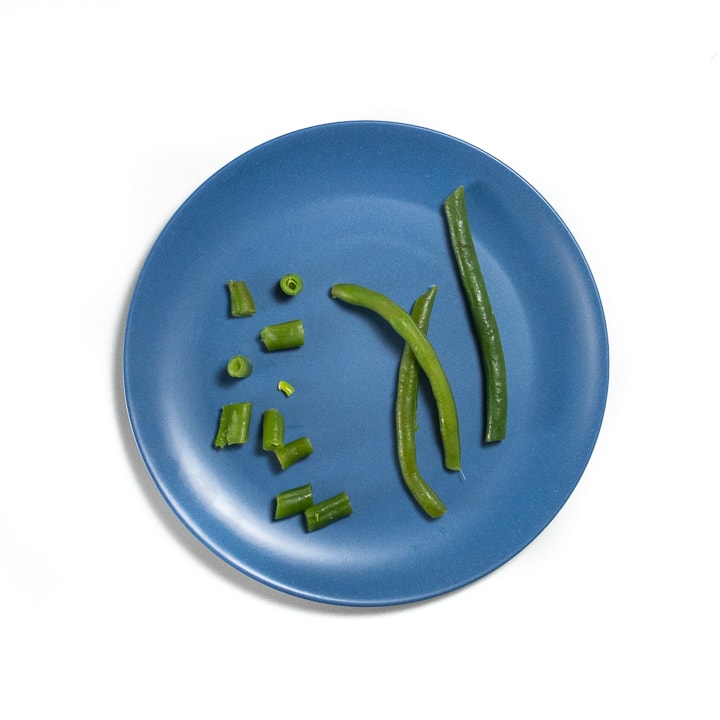 Blue plate with green beans.