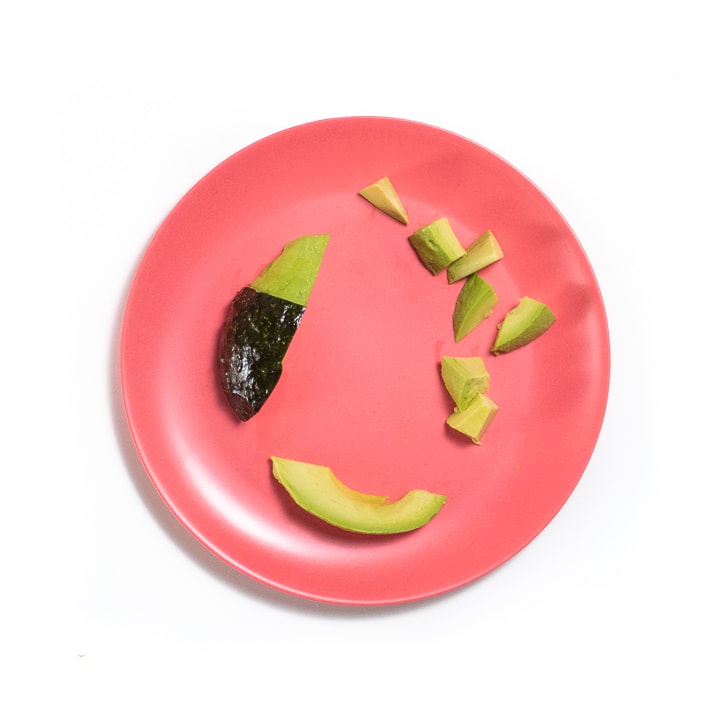 Avocado on a plate 3 different ways.