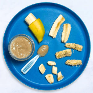 A blue plate with different ways to serve banana to baby. The plate is on my white kitchen counter.