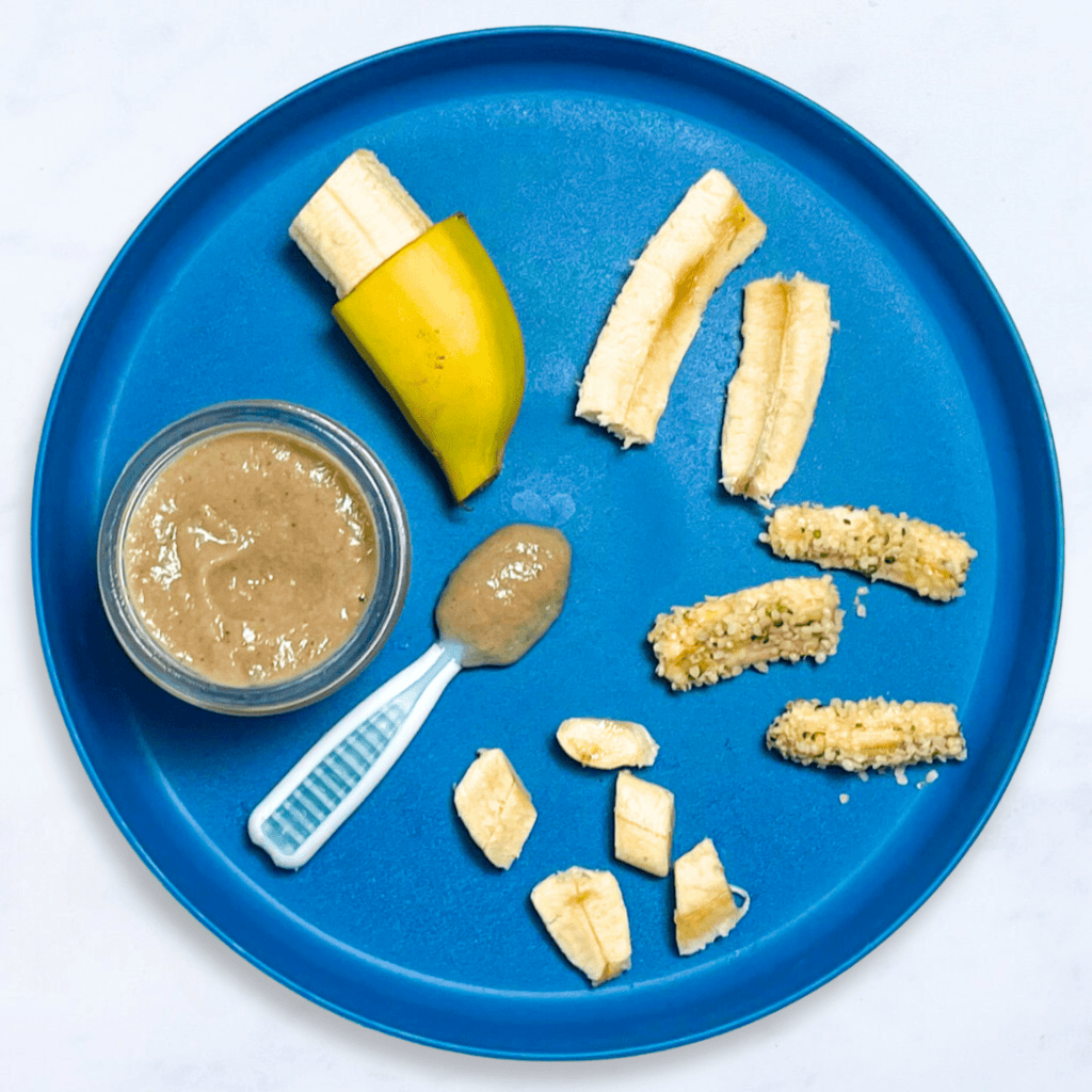 A blue plate with different ways to serve banana to baby. The plate is on my white kitchen counter.