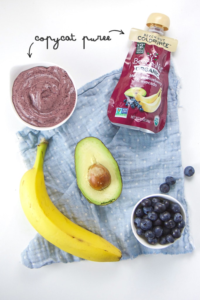 Spread of store bought baby food pouch almong with homemade baby food puree, banana, avocado and blueberries.