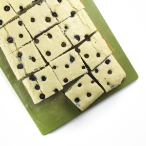 Picture of blueberry sheet pan pancakes sitting on a cutting board.