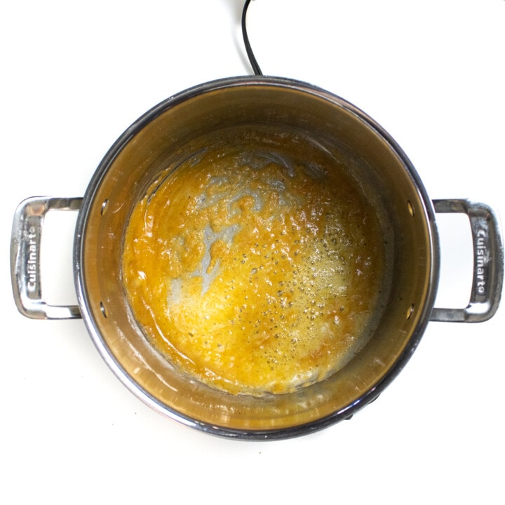 A large silver pot with butter, flour, spaces in salt.