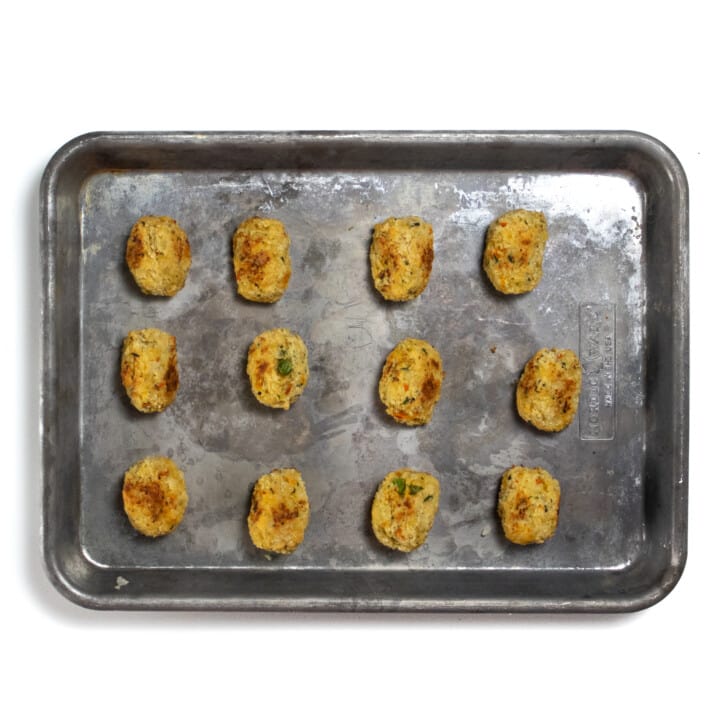 Baked cauliflower tots on a baking sheet.