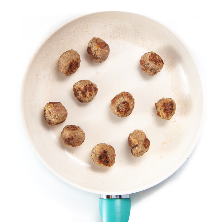 Chicken Parmesan meatballs cooked on the stove top.