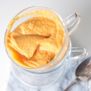 A glass bowl filled with a fall-inspired baby food puree.