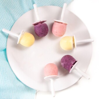 plate filled with yogurt popsicles in three different flavors.