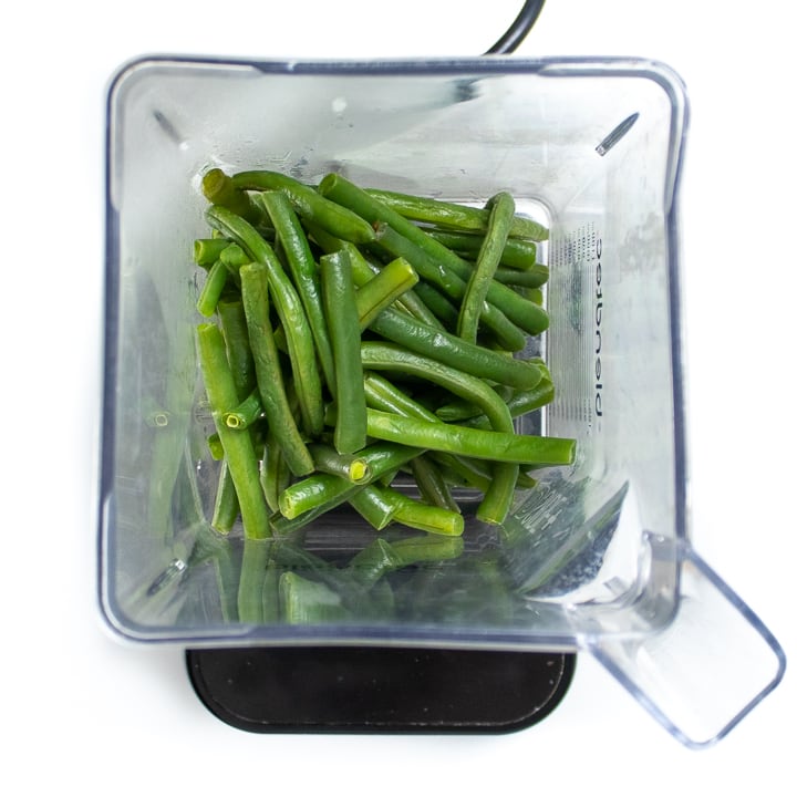 Green beans in a blender getting ready for baby puree. 