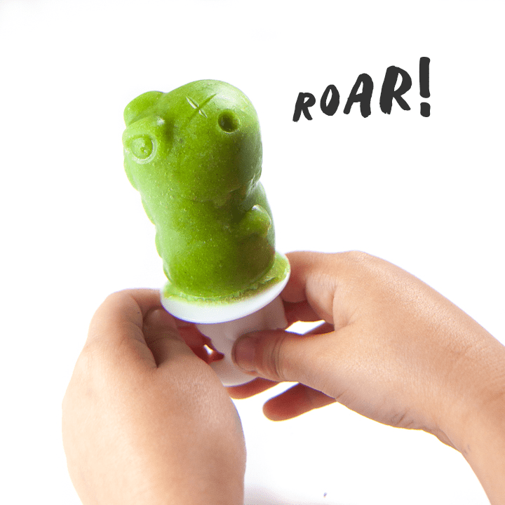 Green smoothie popsicle of a Dino roaring 