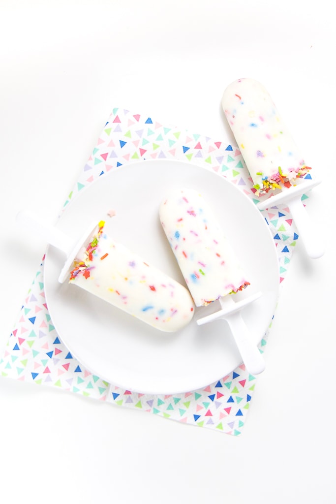 A white plate with 3 healthy funfetti popsicles on top.