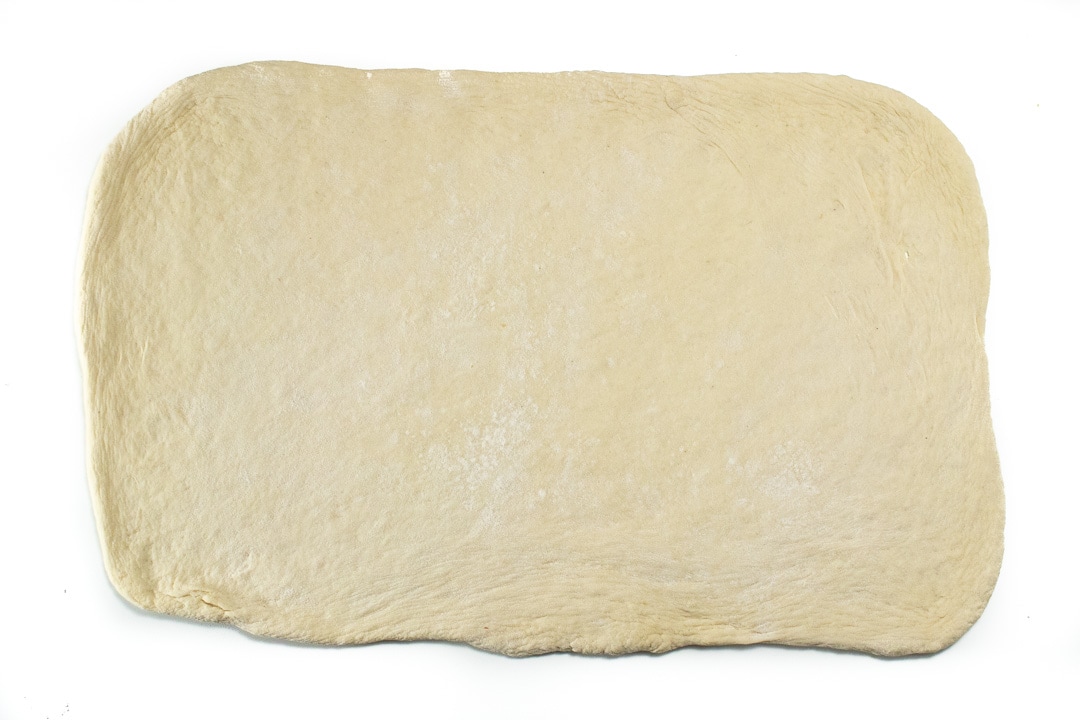 pizza dough rolled out into a rectangle.