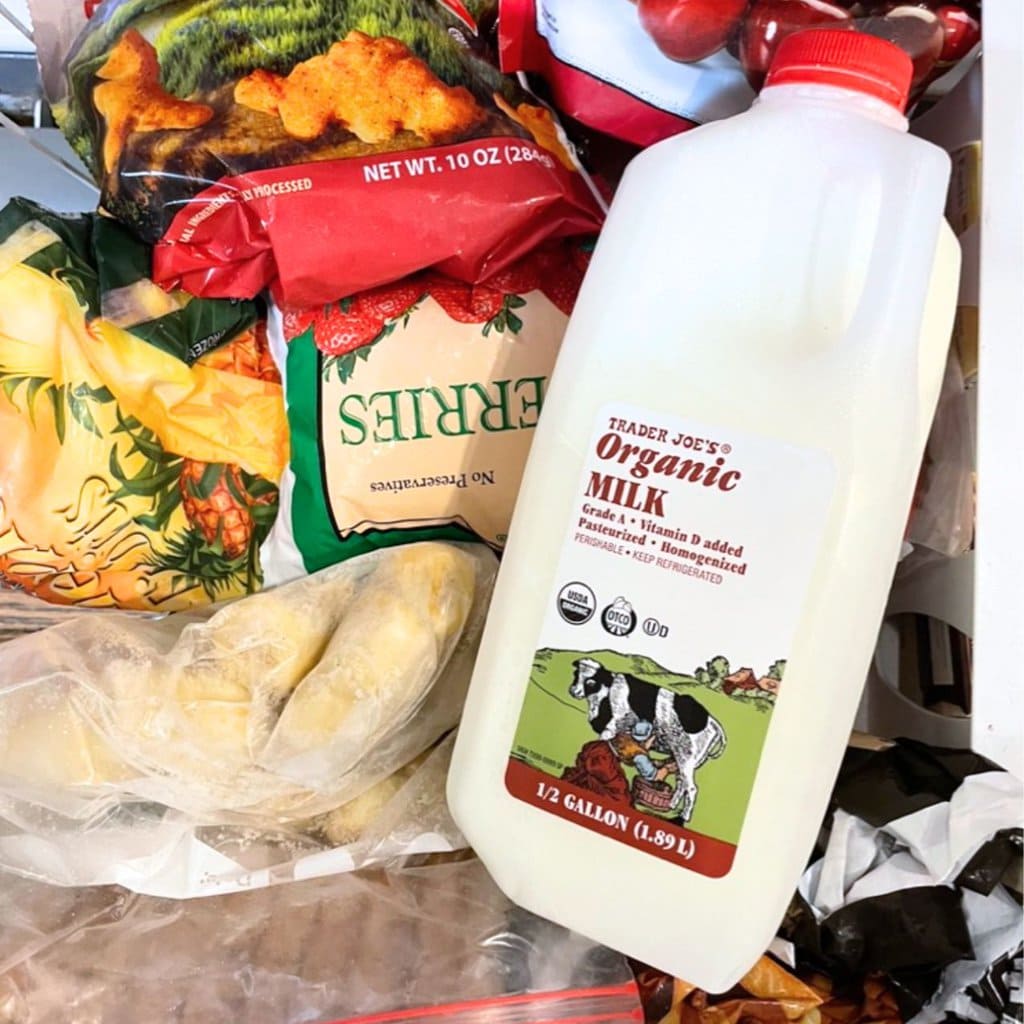 A half gallon of milk in the freezer getting ready to be frozen.