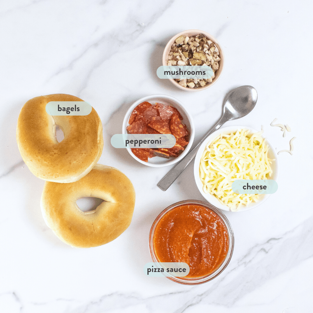 ingredients spread out on a marble counter with labels on what foods are which. 
