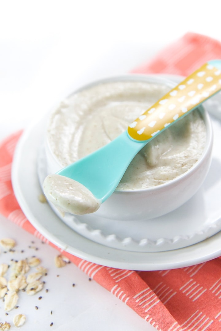 Small white bowl filled with oatmeal for baby.