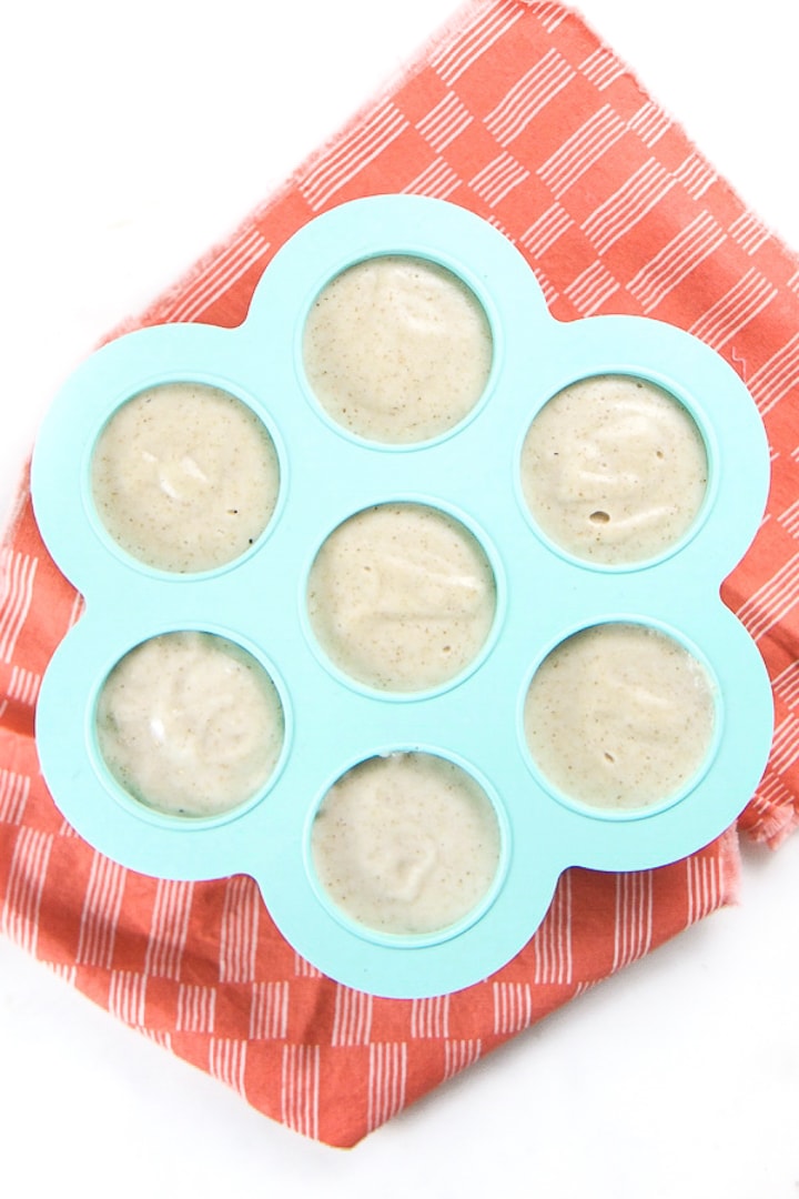 Freezer tray filled with cooked baby oatmeal ready to be frozen.