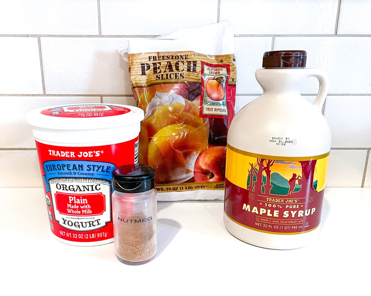 White kitchen with ingredients for peach yogurt spread out.