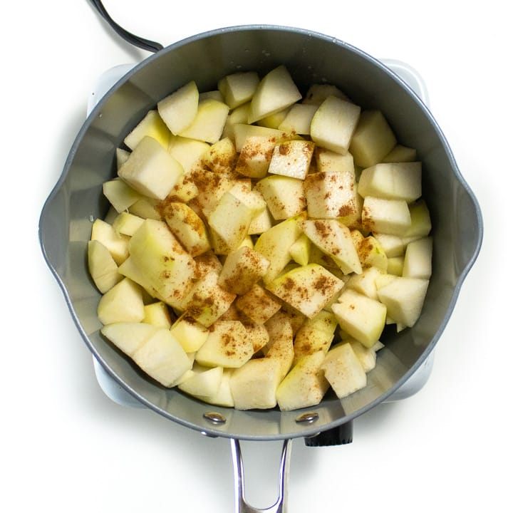 Saucepan with  chopped pears and spices getting ready to book for a homemade baby food puree. 