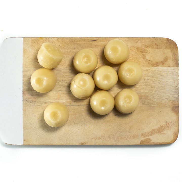 Cubes of frozen pear puree on a cutting board. 