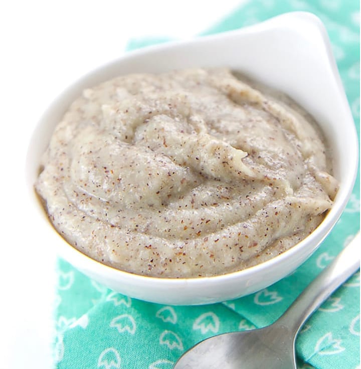 Small white bowl with homemade quinoa cereal for baby.