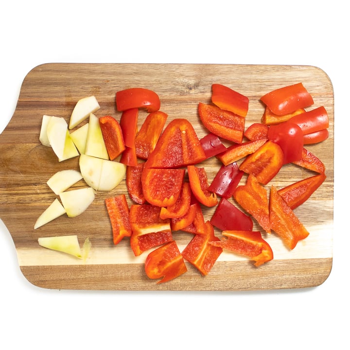 Cutting board with red pepper and pears.