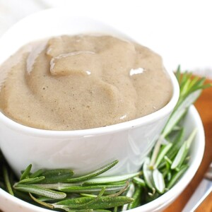 Small white bowl full of homemade banana baby food.