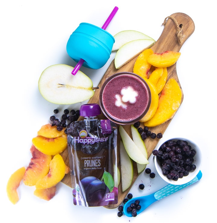 Cutting board with a spread of healthy ingredients for a smoothie for baby and toddler. 