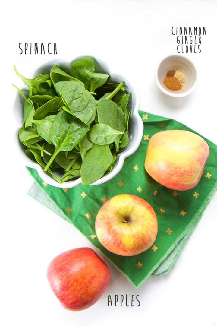 Spread of ingredients for recipe - apples, spinach and spices. 