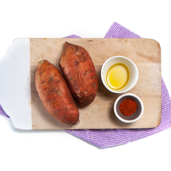 Ingredients for sweet potato wedges on a cutting board for baby and toddler.