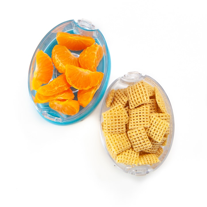 2 snack cups filled with cereal and orange sections.