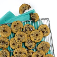 Cooling rack with whole wheat cookies on it with one broken up on the side.