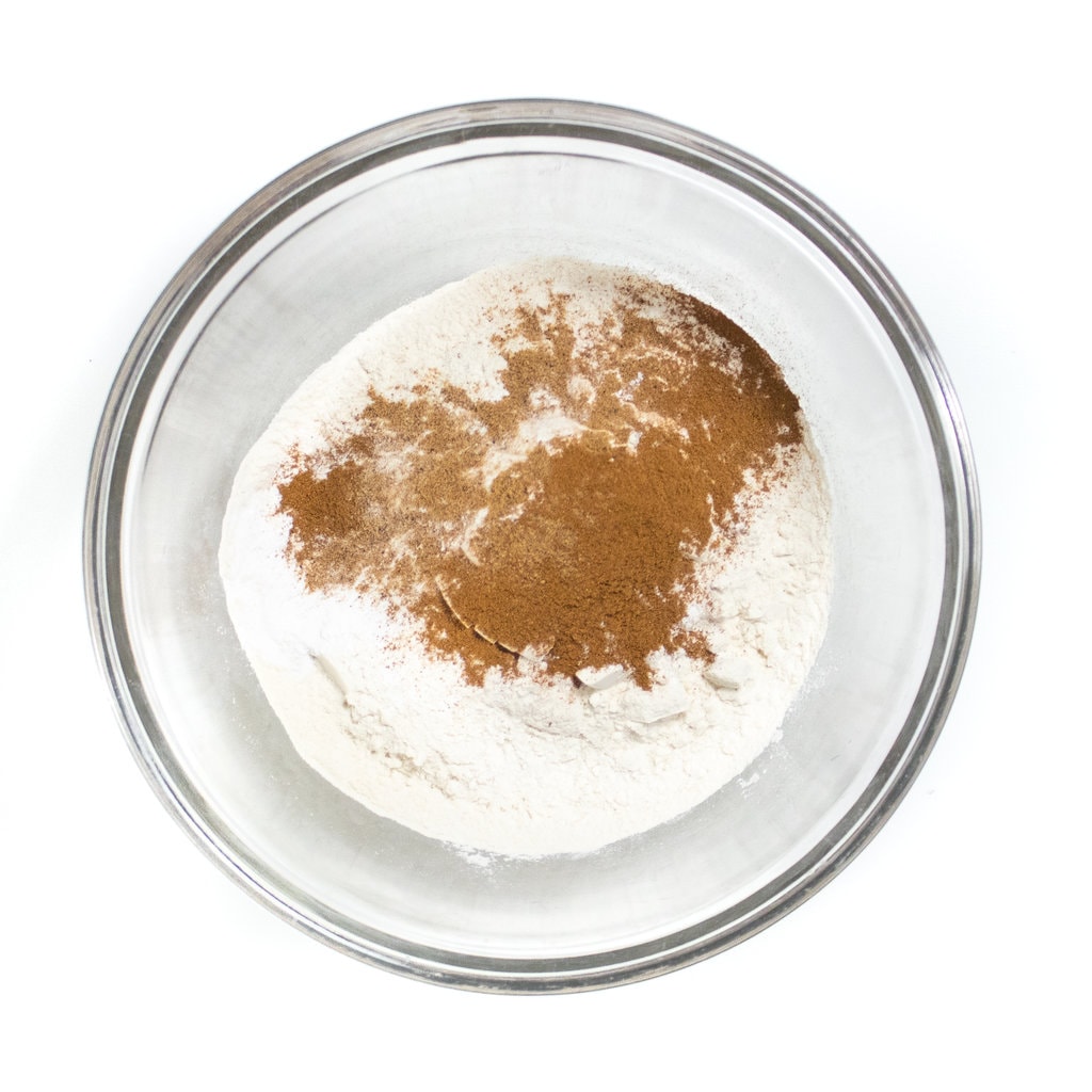 Clear mixing bowl with dry ingredients for pancakes.