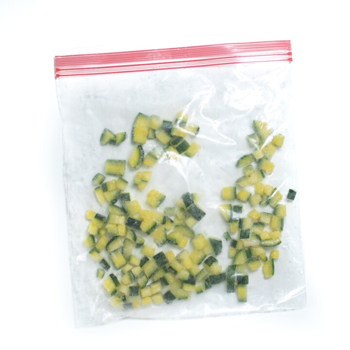 A baggie full of diced frozen zucchini.